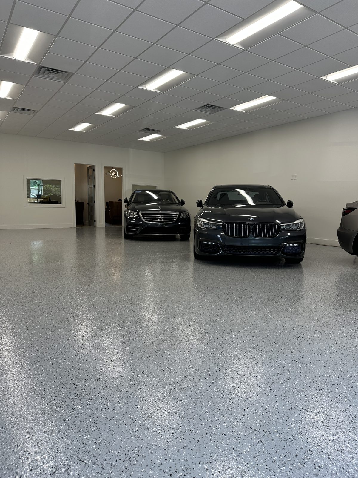 Light grey flake floor coating in a large car showroom