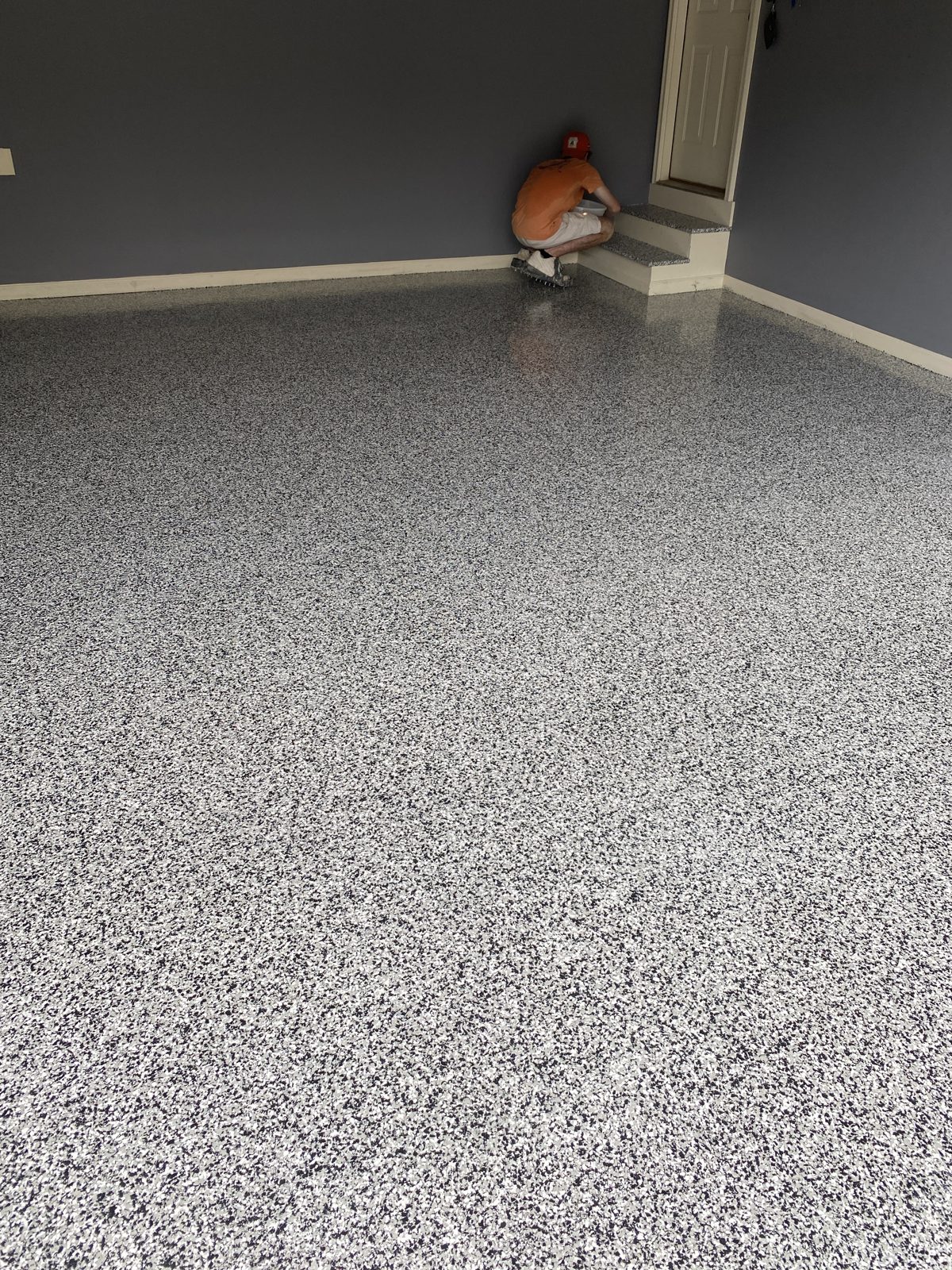 Grey and black flake garage floor coating in a residential garage